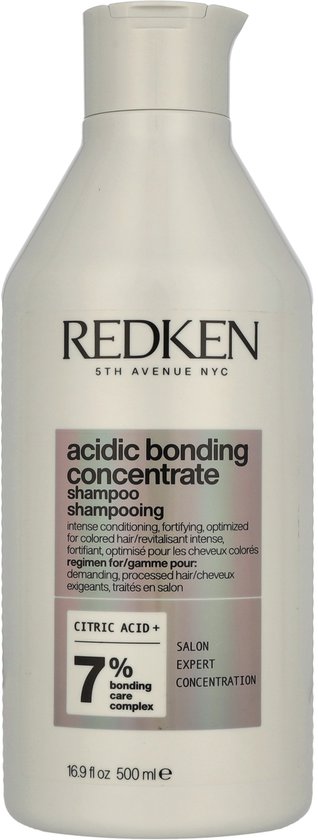 Bouteille de shampooing Redken Acidic Bonding Concentrate de 500 ml avec un corps blanc et des accents argentés et violets.