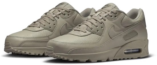 Nike Air Max 90 Premium en cuir gris beige, avec unité Air visible.
