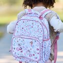 Fille portant un sac à dos avec imprimé floral et de fées, bretelles roses et poche avant.