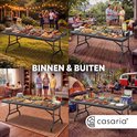 Collage van 4 afbeeldingen: zwarte tafel binnen en buiten met eten en mensen. "Binnen & Buiten".