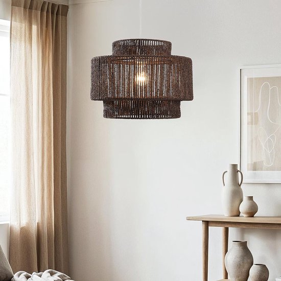 Donkerbruine rotan hanglamp met drie lagen in een woonkamer met lichte gordijnen en meubels.