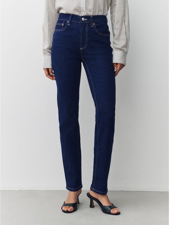 Detail van de donkerblauwe jeans met halfhoge taille, zichtbaar vanaf de voorkant.