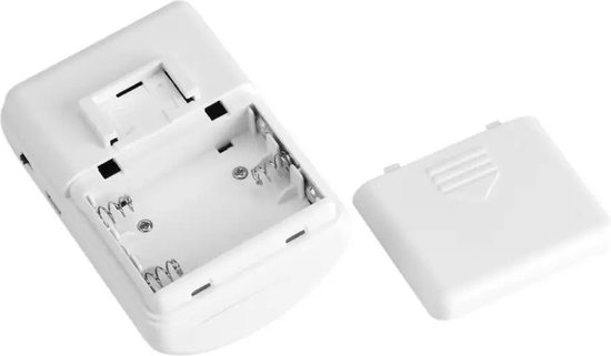 Witte batterijhouder van een draadloze melder, met deksel ernaast.
