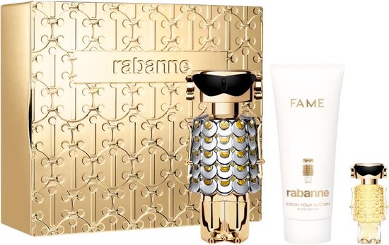 Gouden Rabanne geschenkset met een gouden robot-vormige parfumfles, een witte bodylotion tube en een kleine parfumfles.