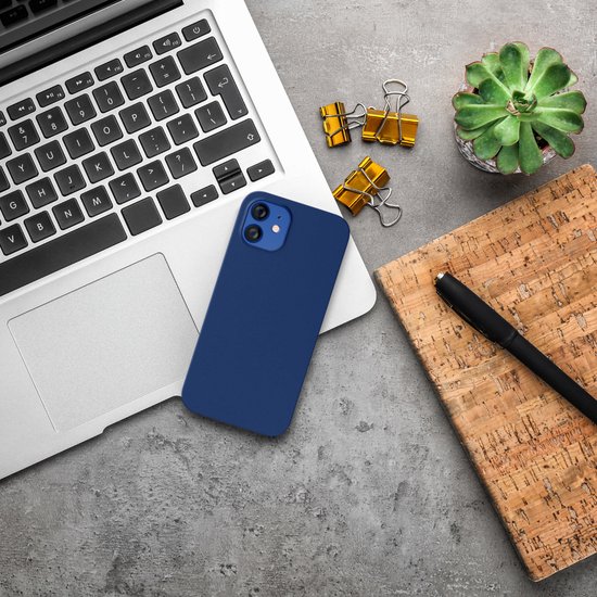 Donkerblauw telefoonhoesje naast een laptop op een bureau, met kantoorbenodigdheden.