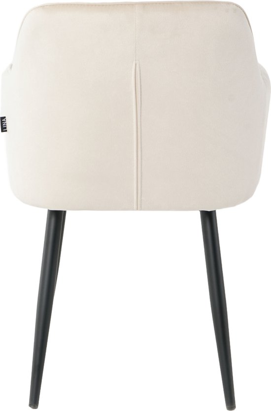 Achterkant van een crème fluwelen eetkamerstoel met zwarte poten en een verticale naad op de rug.