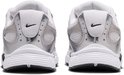 Achterkant van twee witte Nike sneakers met zilverkleurige details en zwarte zolen.