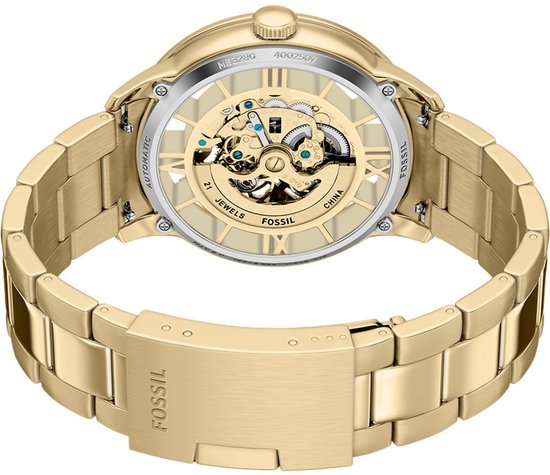 Goudkleurig Fossil skeleton horloge met metalen band, achterkant met zichtbare uurwerkonderdelen.
