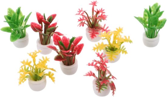 Zeven miniatuur kunstplantjes in witte potjes: groen, rood en geel.