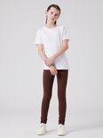 Meisje met een witte T-shirt en bruine legging.