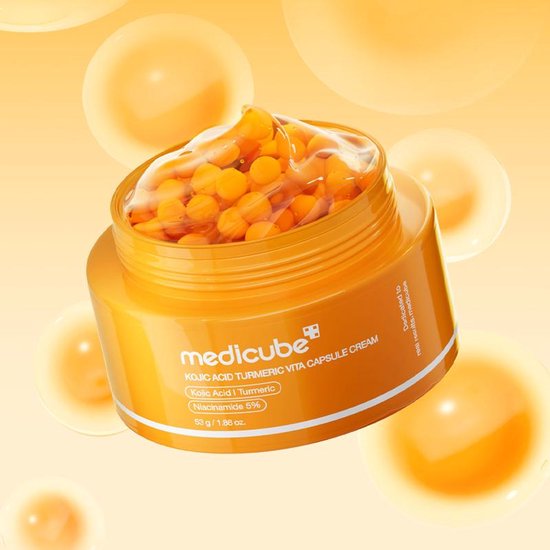 Medicube KOJIC ACID TURMERIC VITA CAPSULE CREAM pot met oranje capsules en een gele crème.