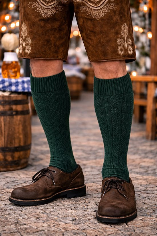 Man met bruine lederen broek en schoenen, draagt donkergroene gebreide kniekousen.