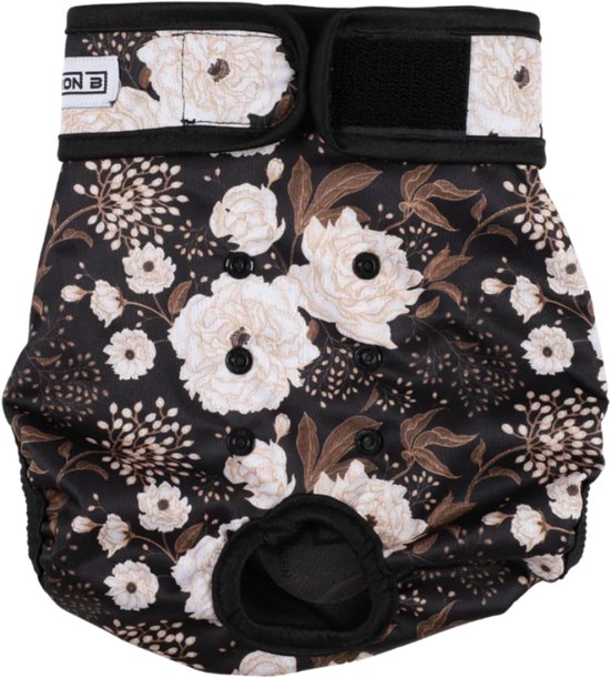 Loopsheidbroekje met zwarte basis en beige bloemenprint. Klittenbandsluiting bovenaan en klittenband aan de zijkanten.