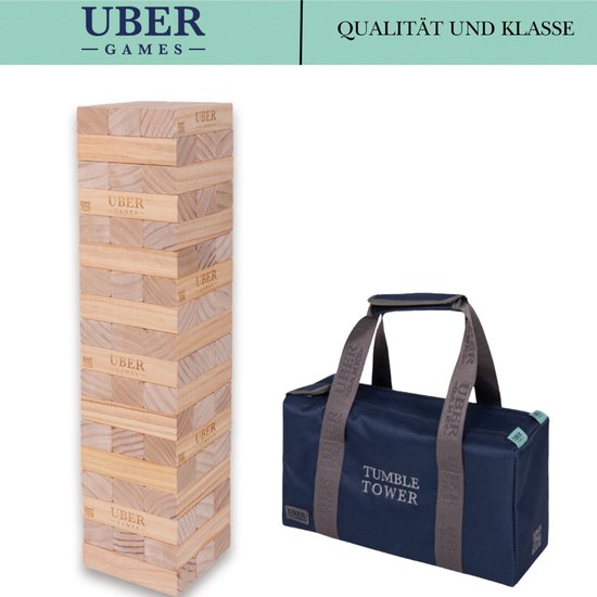 Houten stapeltoren en donkerblauwe draagtas met "TUMBLE TOWER" opdruk en "UBER GAMES" logo's. "QUALITÄT UND KLASSE" tekst rechtsboven.