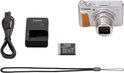Canon PowerShot SX740 HS camera met oplader, batterij, USB-kabel en polsband.