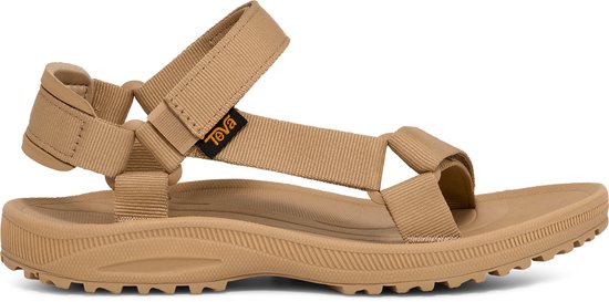 Sandale Teva beige avec brides, présentée sur fond noir. Vue latérale mettant l'accent sur la semelle.