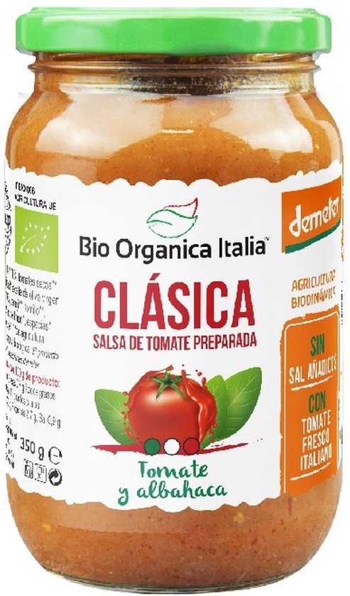 Pot met 'Bio Organica Italia Clásica' tomatensaus met basilicum. Groene deksel, oranje-rode saus met groene bladeren en een tomaat op het etiket.
