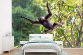 Behang - Fotobehang Springende aap in de jungle - Breedte 360 cm x hoogte 240 cm