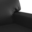 Close-up van de zwarte kunstleren zitting van een fauteuil.