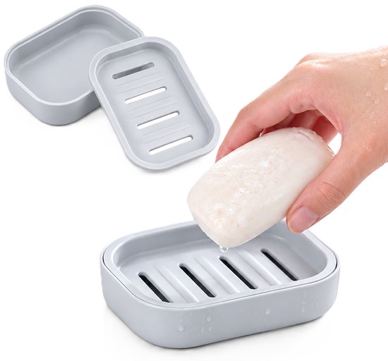 Porte-savon gris avec égouttoir, deux parties et main avec savon.