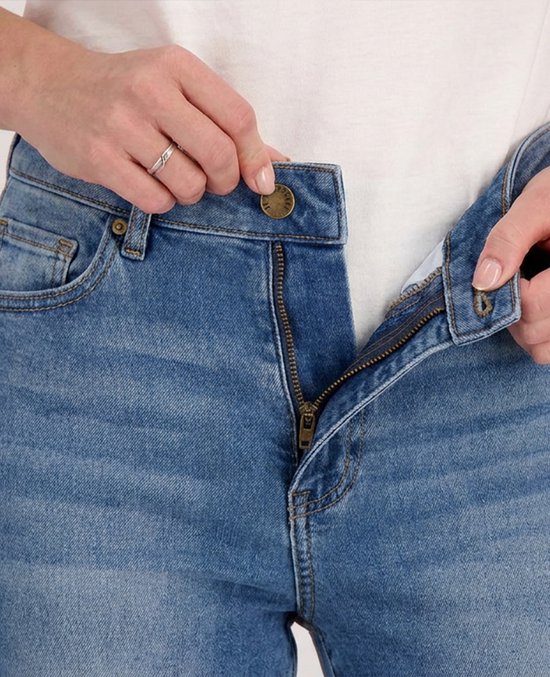 Dichtbij opname van de tailleband van een blauwe denim jeans met knoop en ritssluiting.