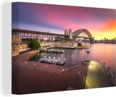 Canvas Schilderij Zonsopgang achter de Sydney Harbour Bridge in Australië - 120x80 cm - Wanddecoratie