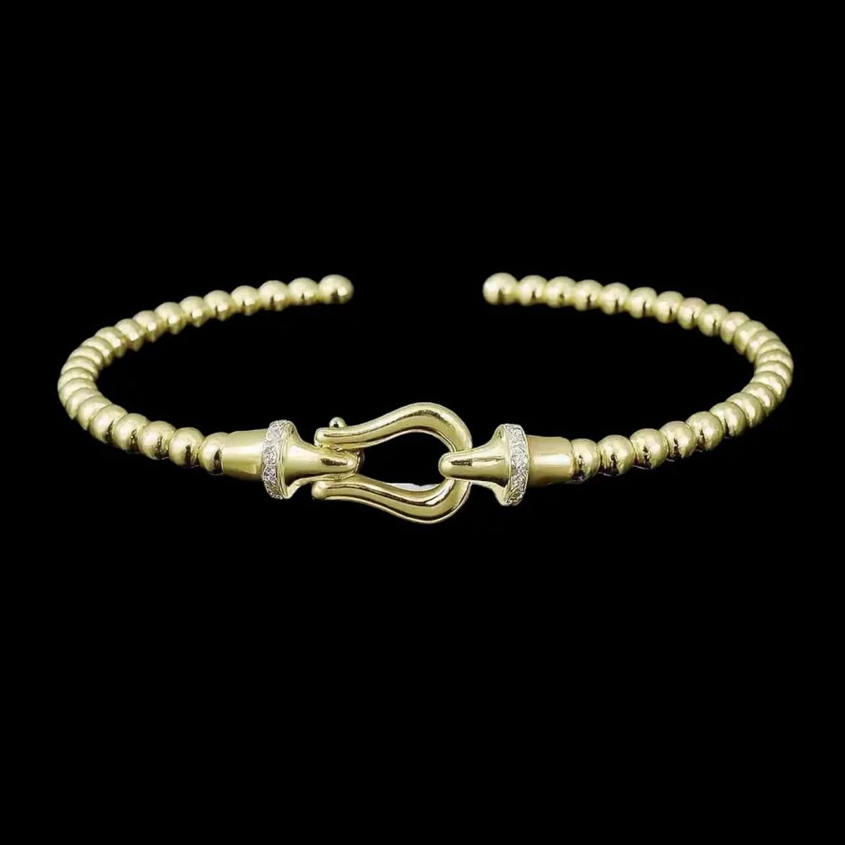 Victoria Valenza Goudkleurige Bolletjes Flexarmband met Haaksluiting en Zirkonia Stenen - Armband - Goudkleurig - Zirkonia