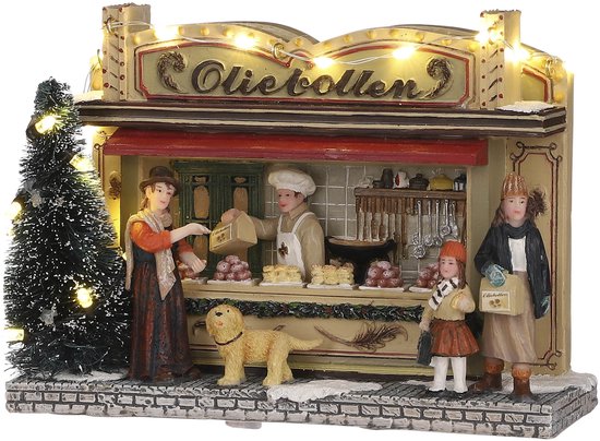 Miniatuur oliebollenkraam met verlichting en drie figuren, waaronder een vrouw, een verkoper en een kind.
