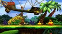 Donkey Kong court sur un chemin dans une jungle avec des bananes, des palmiers et un dirigeable.