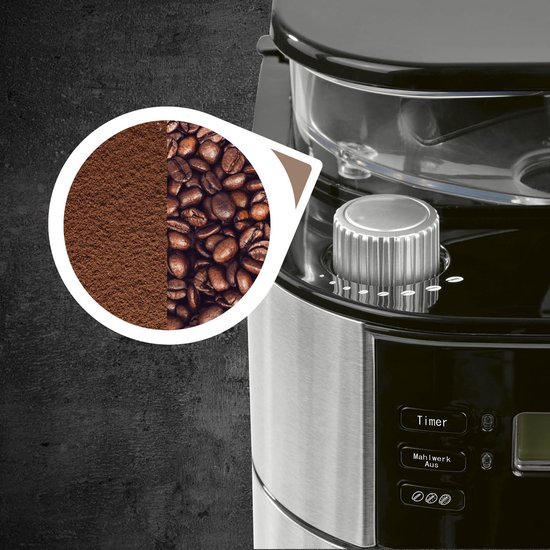 Close-up van de bovenkant van een zwart en RVS koffiezetapparaat met bonen en gemalen koffie.