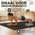 Vrouw in plankpositie op een zwarte insteekmat, met dumbbells ernaast, in een slaapkamer.