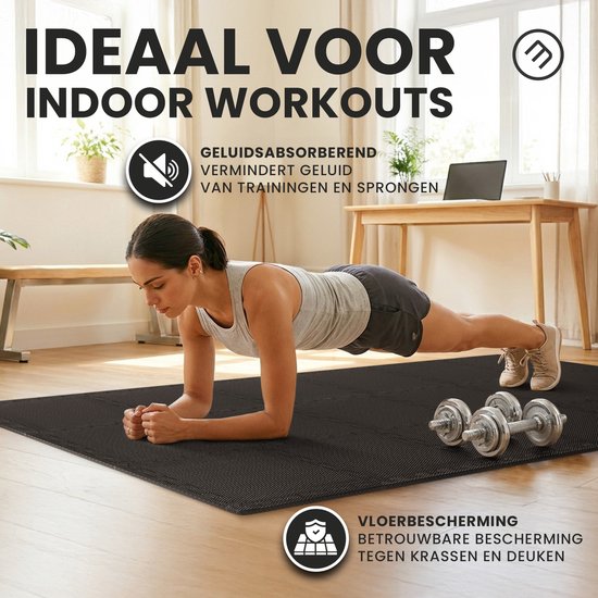 Vrouw in plankpositie op een zwarte insteekmat, met dumbbells ernaast, in een slaapkamer.