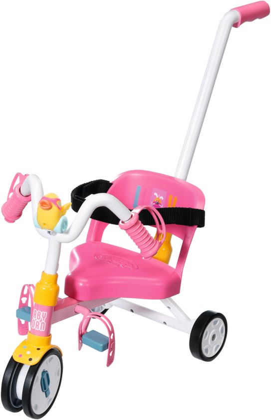 Roze driewieler met gele details, een duwstang en een geel eendje voorop.