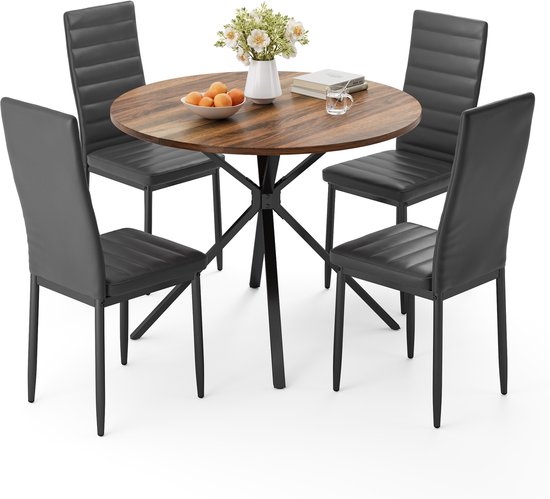 Ronde eettafel met vier zwarte stoelen op witte achtergrond.