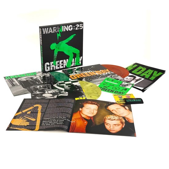 Green Day "Warning: 25" boxset met boek, 4 gekleurde vinylplaten en plectrum. De box is zwart met groene opdruk "Warning: 25".