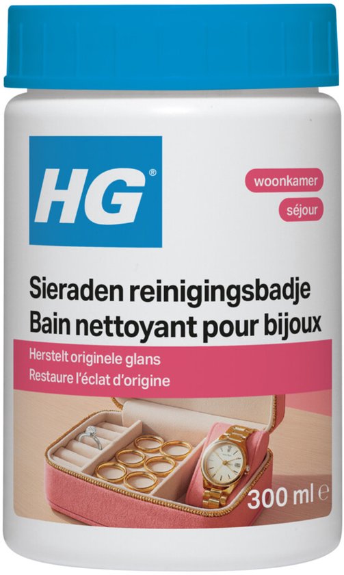 HG sieraden reinigingsbadje met een open roze juwelendoos met gouden ringen en een horloge.