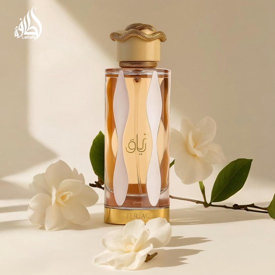 Glazen parfumfles Teriaq Lattafa met oranje vloeistof, witte accenten en een gouden slang-dop, met witte bloemen.