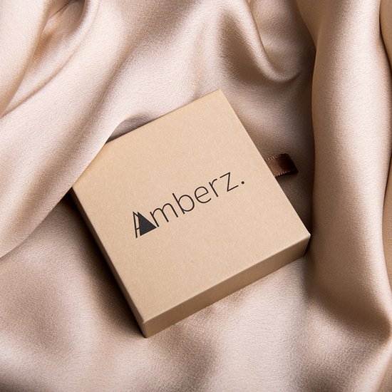 Gouden Amberz. geschenkdoosje op een crèmekleurige satijnen stof.