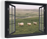 Doorkijk schilderij - Schaap - Gras - Landschap - Berg - Zwart raam - Canvas doorkijk - Schilderij doorkijk - Wanddecoratie - 60x40 cm