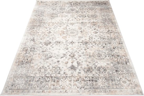 Un tapis gris clair avec un motif oriental vintage délavé et une bordure grise.