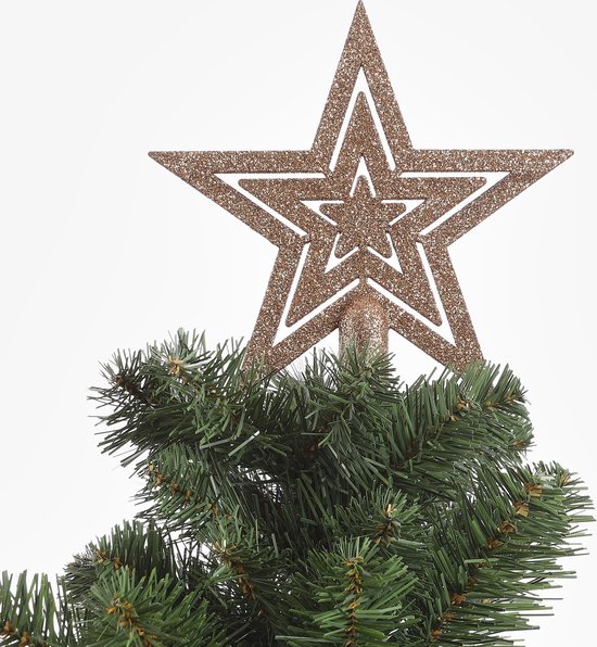 Pointe d'étoile brun cuivre pailletée sur un sapin de Noël vert.