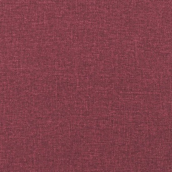 Textuur van de donkerrode stof van de fauteuil.