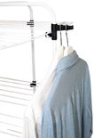 Wit strijkrek met een blauw en wit shirt hangend aan hangers.