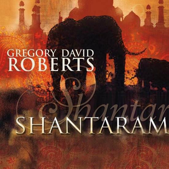 Boekcover van Shantaram met een olifant en Indiase architectuur op een oranje achtergrond.