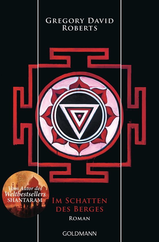 Boekomslag met een rode en witte mandala met een driehoek in het midden. De tekst luidt 'GREGORY DAVID ROBERTS IM SCHATTEN DES BERGES'.