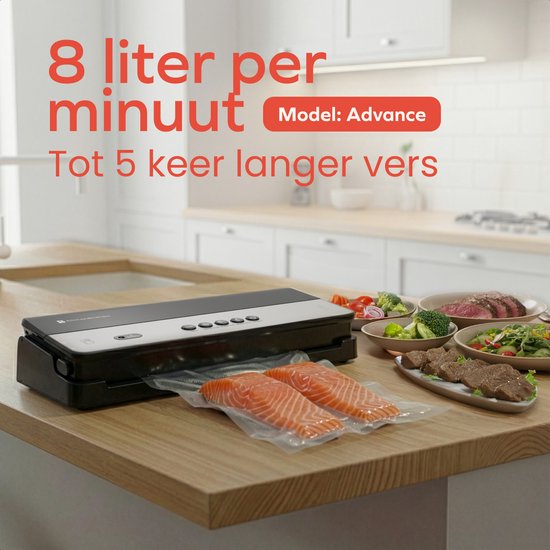 Zwarte 'Advance' vacuümmachine op een houten aanrecht, omringd door gerechten zoals zalm, steak en salade.