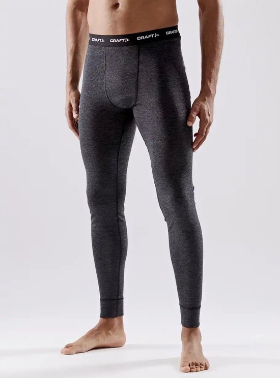 Man draagt donkergrijze wollen thermolegging met zwarte 'CRAFT' band. Zwart tegen grijze achtergrond.