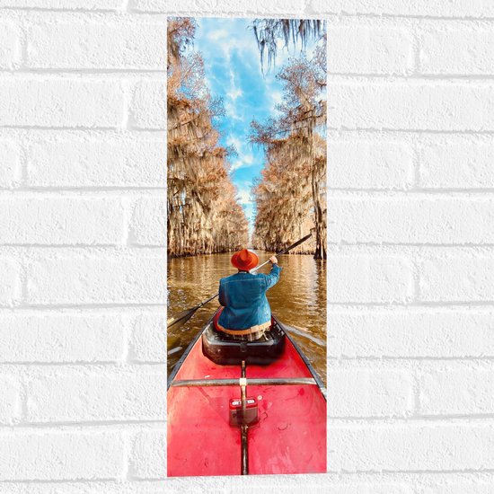 WallClassics - Muursticker - Persoon in Kano tussen Prachtige Bomen onder Blauwe Lucht met Kleine Wolkjes - 20x60 cm Foto op Muursticker