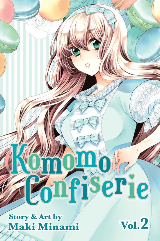 Komomo Confiserie Vol. 2. Manga met een anime-meisje met lang blond haar, blauwe kleding en macarons op de achtergrond.