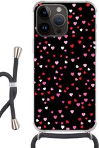 Geschikt voorApple Iphone 14 Pro - Crossbody Case - Een illustratie met hartjes op een zwarte achtergrond - Siliconen - Crossbody - Backcover met Koord - Telefoonhoesje met koord - Hoesje met touw